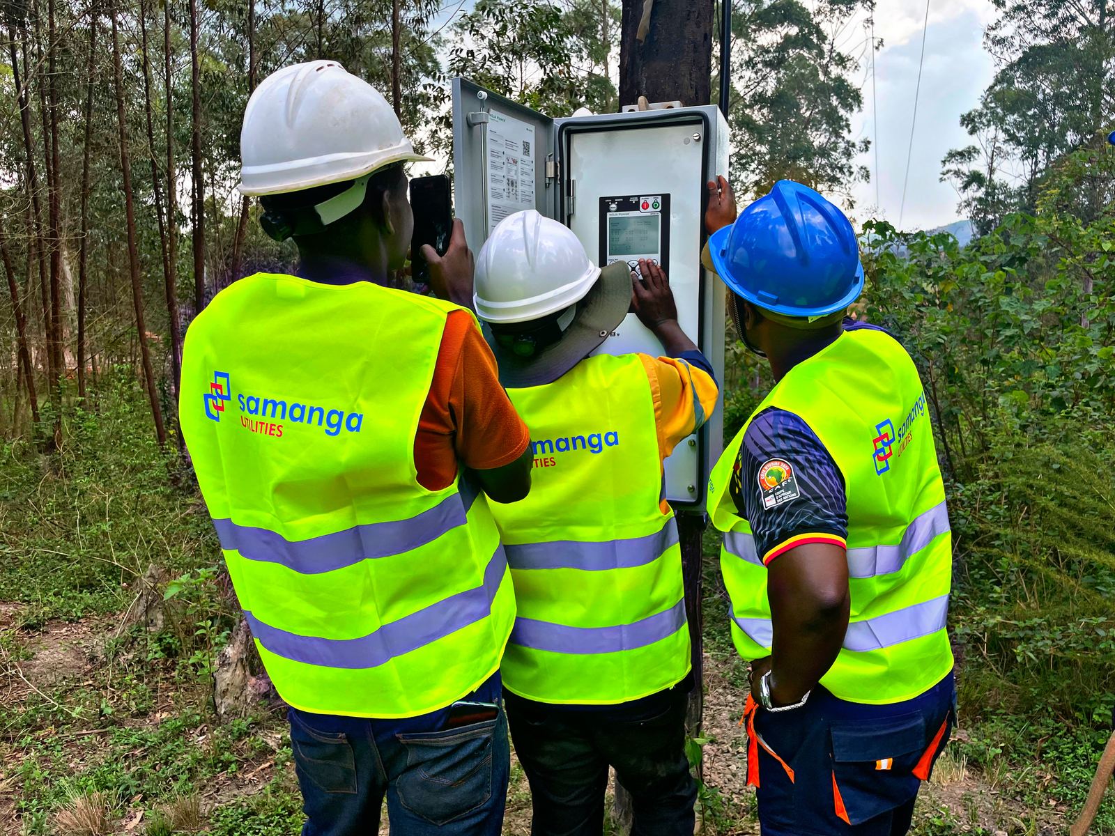 Samanga engineers at a control cabinet on site