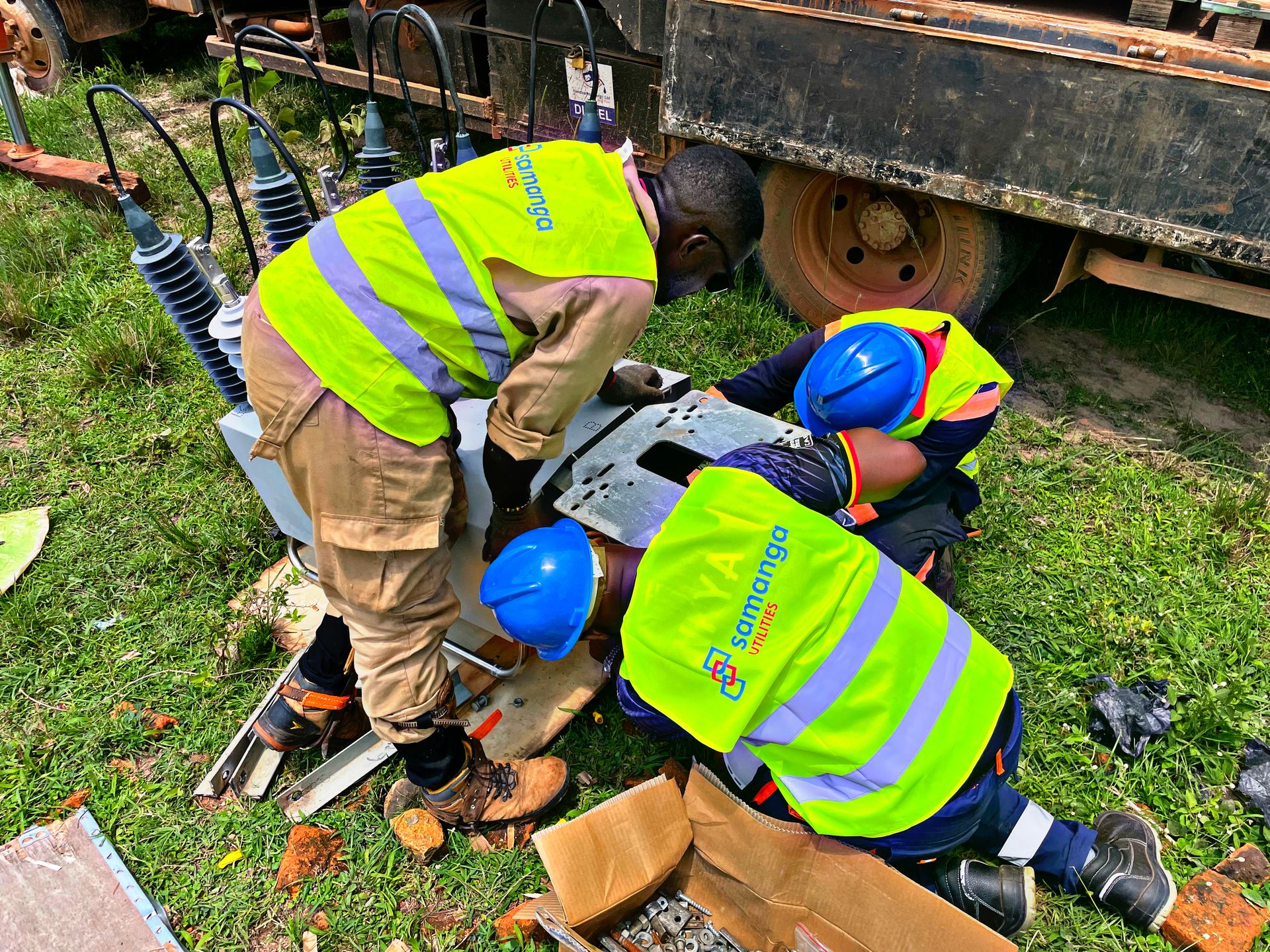 Samanga Utilities crew in branded high-visibility gear working on distribution equipment